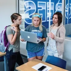 Sport management students in classroom overlooking athletic facilities.